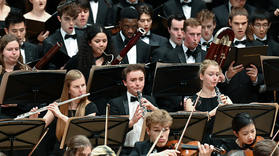 The woodwind section of the RCM Symphony Orchestra performing in a concert 